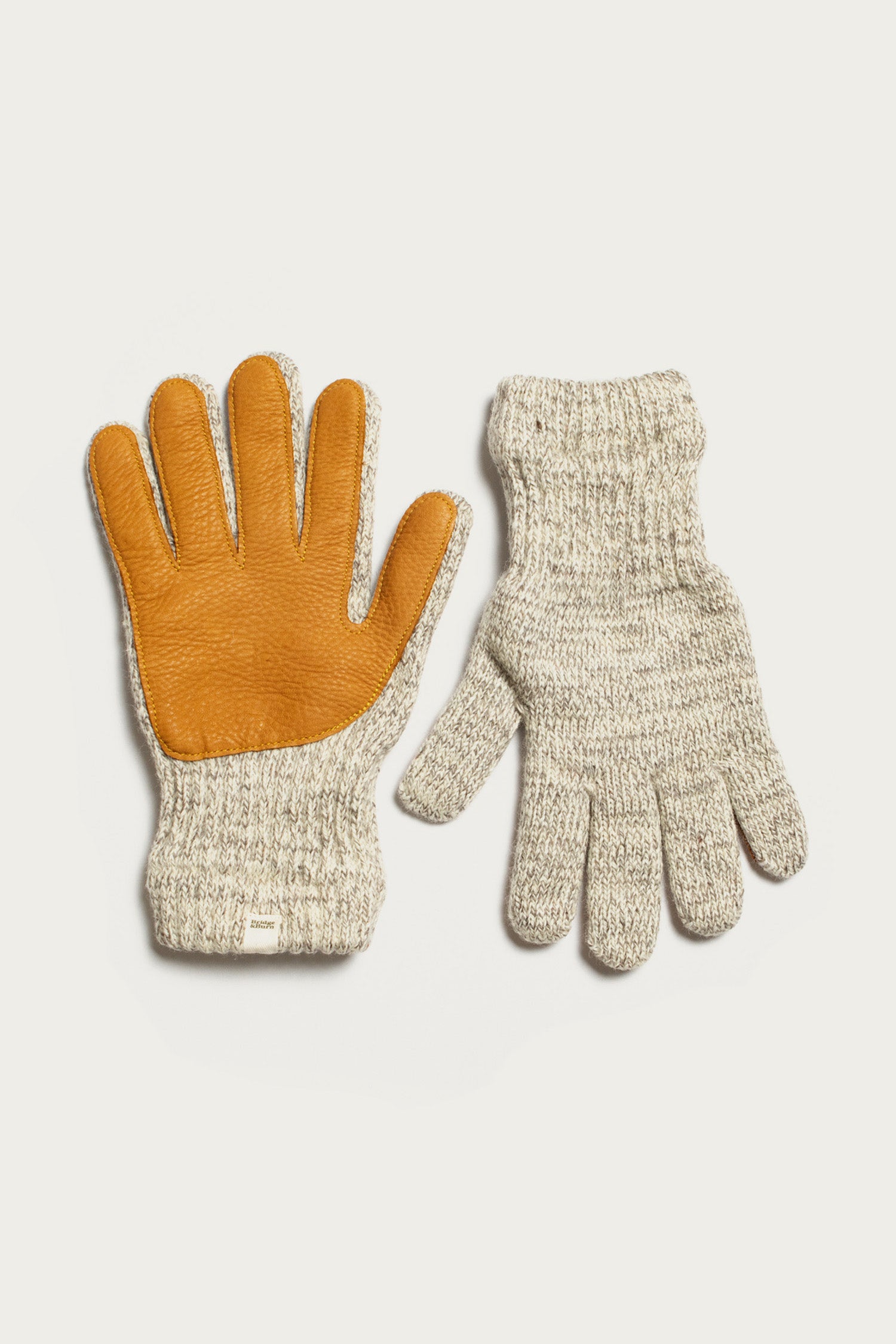 Bridge & Burn’s Ragg Wool Lined Glove in Oatmeal shown flat on a white background—one glove features a tan leather palm, while the other is fully knitted with no leather.
