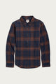 The Bridge & Burn Larson Shirt in Cinder Plaid is a classic-fit, long-sleeve button-up crafted from organic cotton with a navy blue and brown brushed flannel plaid pattern, featuring a classic collar and front pocket, shown laid flat on a white background.