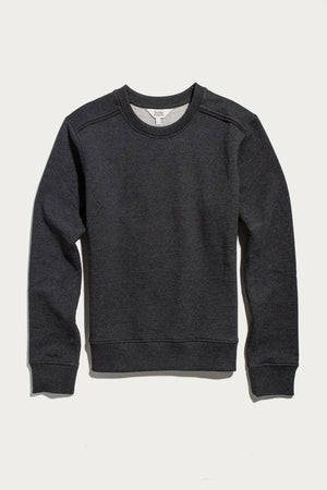 The Bridge & Burn Bailey Crew Sweatshirt in Graphite, a sustainable long-sleeve crewneck with ribbed cuffs and hem, is laid flat on a light background. Simple seams run along the sleeves and shoulders.