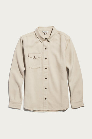 A Bridge & Burn Bird Shirt in Fawn Flannel, featuring a collared neckline, long sleeves, button-up front, and a single chest pocket, made from organic cotton flannel in a relaxed fit, is laid flat on a white background.