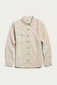 A Bridge & Burn Bird Shirt in Fawn Flannel, featuring a collared neckline, long sleeves, button-up front, and a single chest pocket, made from organic cotton flannel in a relaxed fit, is laid flat on a white background.