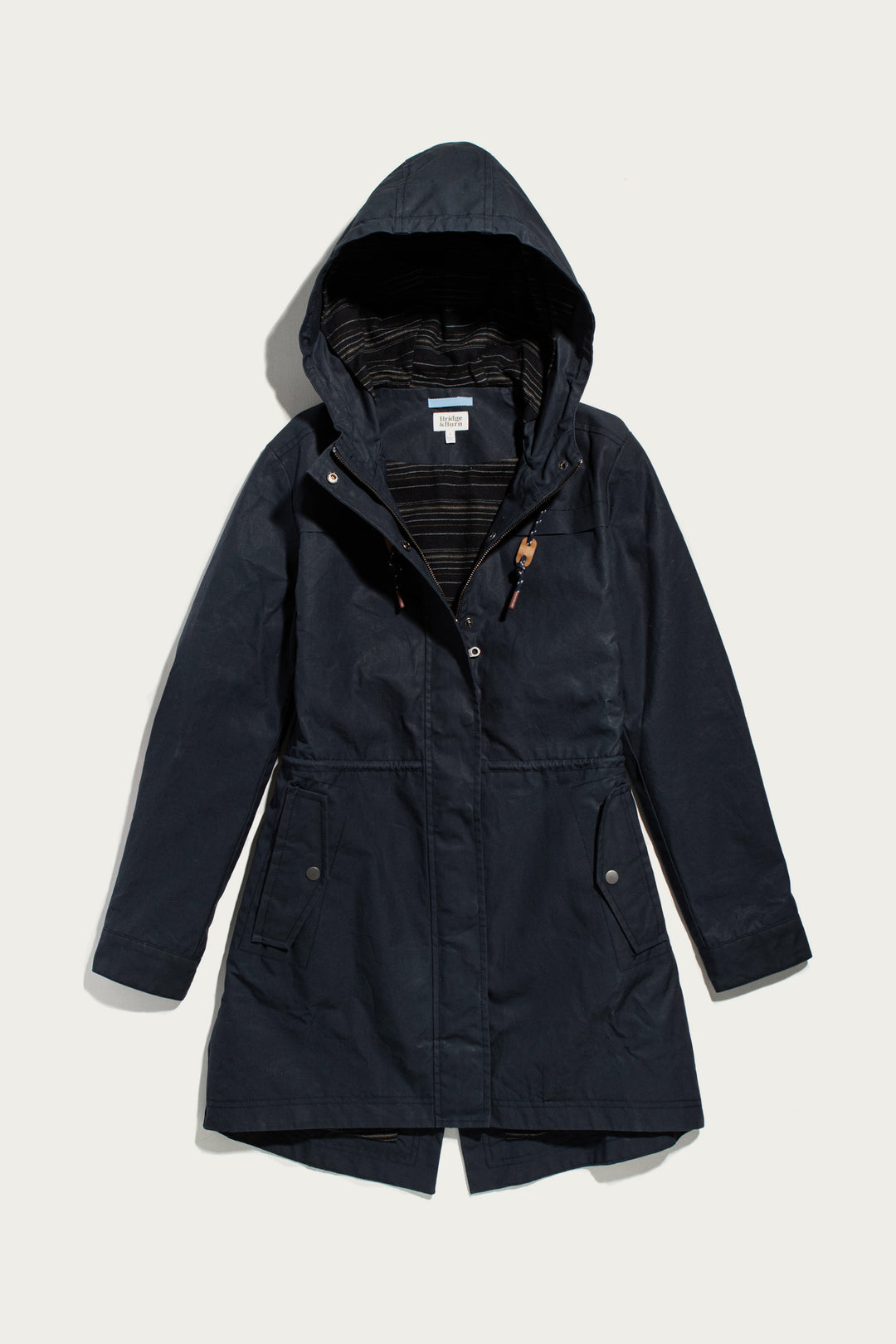 Navy Briar Jacket / Navy Waxed Canvas hooded parka with a front zipper, snap buttons, and a drawstring waist for a rain-ready fit.