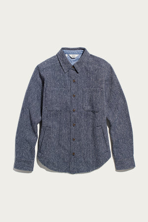 The Bridge & Burn Dawson Overshirt in Ocean Marl, featuring a blue textured design with two chest pockets and long sleeves, is crafted from recycled cotton for a sustainable choice and is shown laid flat on a white background.