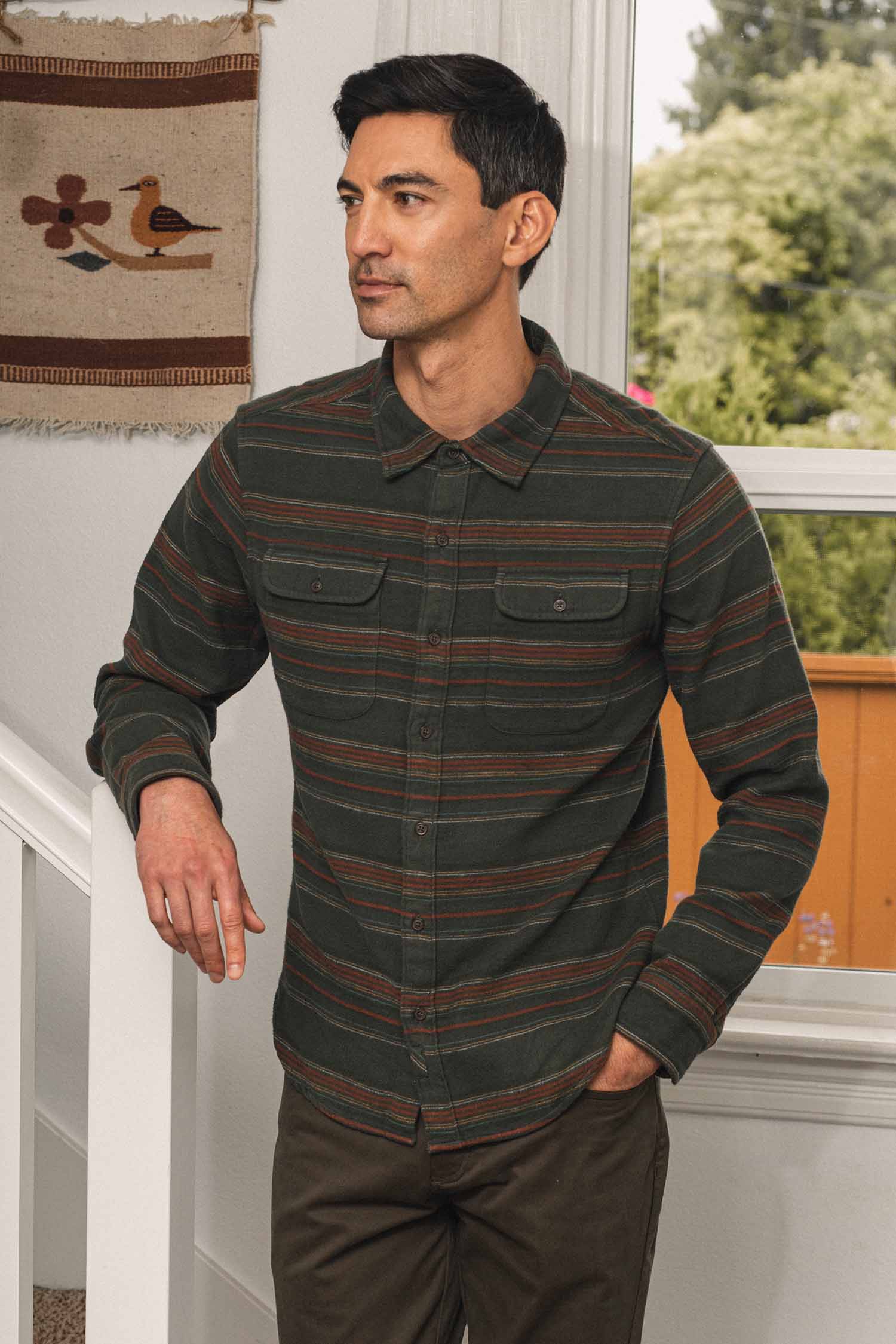Bridge & Burn Cole Slim Shirt / Mallard Stripe, a slim fit, long-sleeved, button-down shirt featuring horizontal dark green, rust, and brown stripes and two chest pockets.