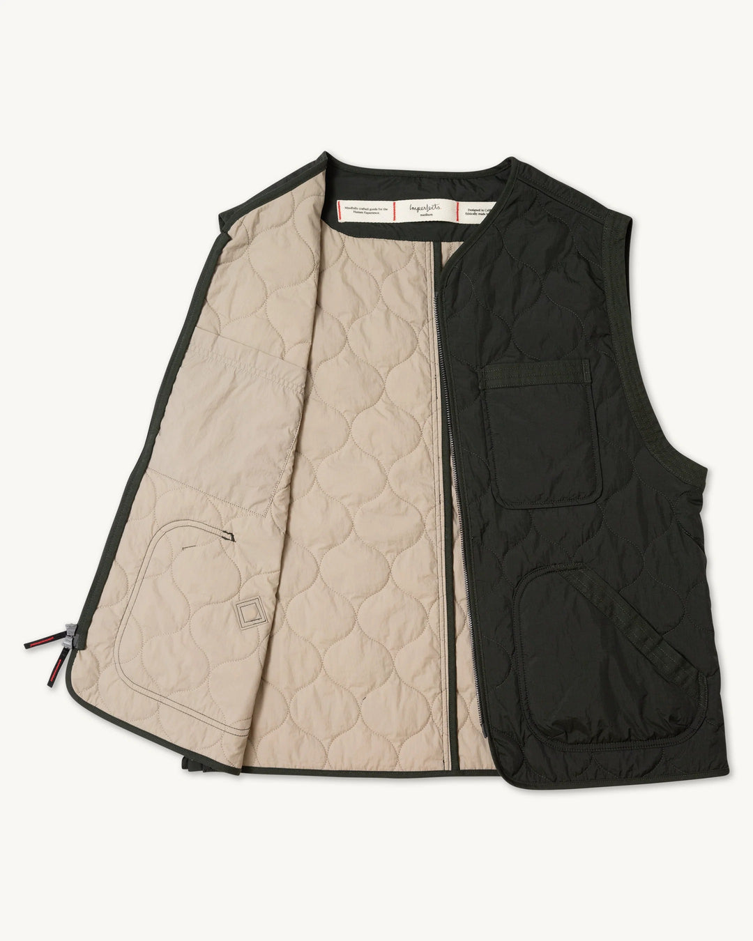 Imperfects Shokunin Vest in Quilted Nylon / Greenroom featuring a quilted nylon ripstop utility shirt with a black exterior, two pockets, and a tan interior lining.