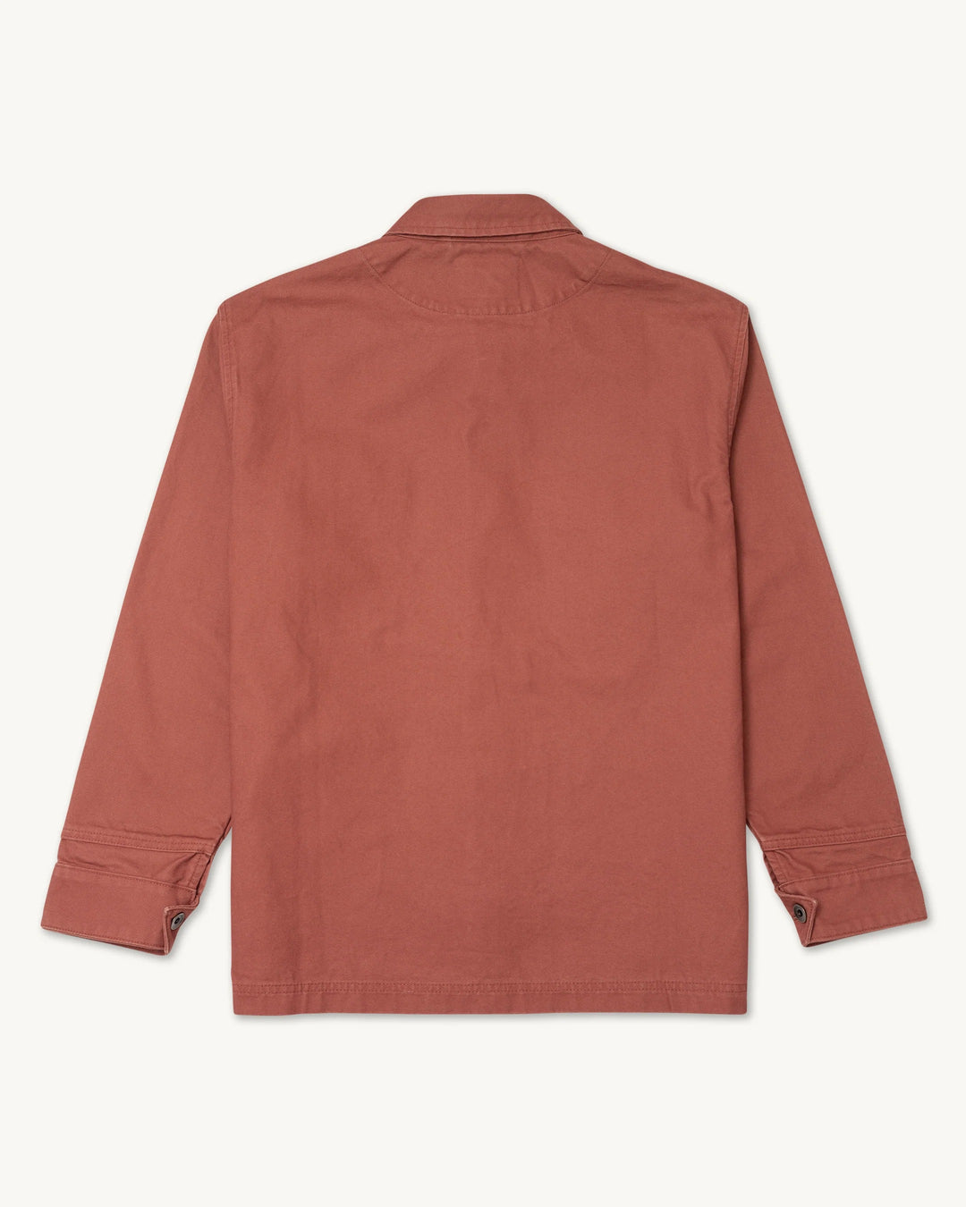 Back view of the Imperfects Cunningham Coat in Craft Canvas / Oxide, a long-sleeved, rust-colored chore coat with a collar and cuffs.
