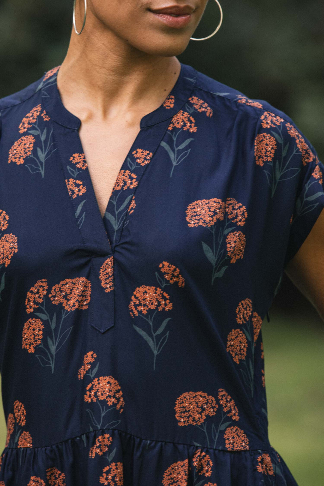 Bridge & Burn Ira Dress in navy blue modal with a split neckline, short sleeves, and an orange wildflower print.