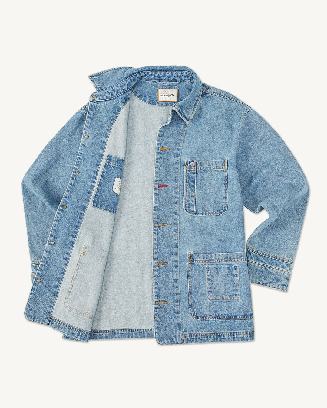 Imperfects Cunningham Coat in light-wash Primo Denim featuring a button front, a chest pocket, and two lower pockets.