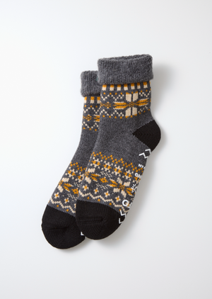 RoToTo Comfy Room Snow Flake Socks in D. Gray feature cozy, chunky construction with yellow, white, and orange geometric patterns, folded at the top and displayed on a white background.
