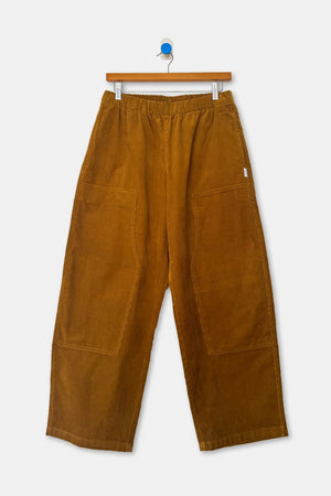 Le Bon Shoppe Gardener’s Pant in Whiskey Corduroy, featuring a relaxed-silhouette, wide-leg fit, elastic waist, and large patch pockets.