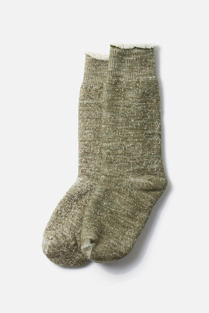 A pair of RoToTo Double Face Crew Socks in Army Green, featuring ribbed cuffs and a speckled organic cotton design, displayed side by side on a white background.