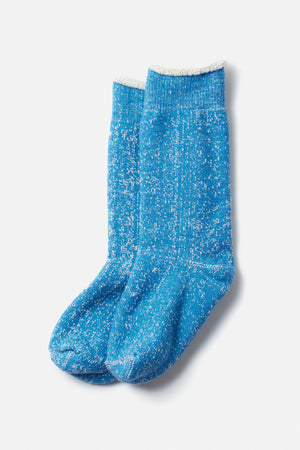 RoToTo Double Face Crew Socks in blue by RoToTo feature a crew length, organic cotton blend, white speckles, and a soft fuzzy white inner cuff, shown on a plain white background.