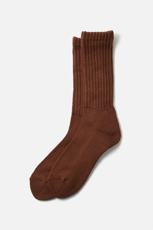 A pair of RoToTo Loose Pile Crew Socks in Chocolate, made in Japan, lay flat on a white background with one sock slightly overlapping the other.
