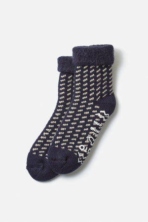 RoToTo Comfy Room Bird's Eye Socks in navy by RoToTo feature a blue and white pattern, textured cuffs, and non-slip grip soles for safety and comfort. Displayed on a plain white background.