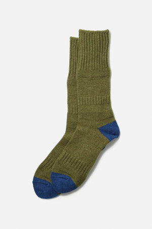 A pair of RoToTo Guernsey Pattern Socks in medium green with blue accents, featuring ribbed cuffs and crafted from merino wool, are laid flat on a white background.