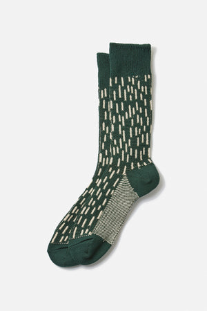 A pair of RoToTo Rain Drop Crew Socks in Dark Green Ivory, featuring cream vertical dash patterns and a textured heel and sole, is displayed against a plain white background.