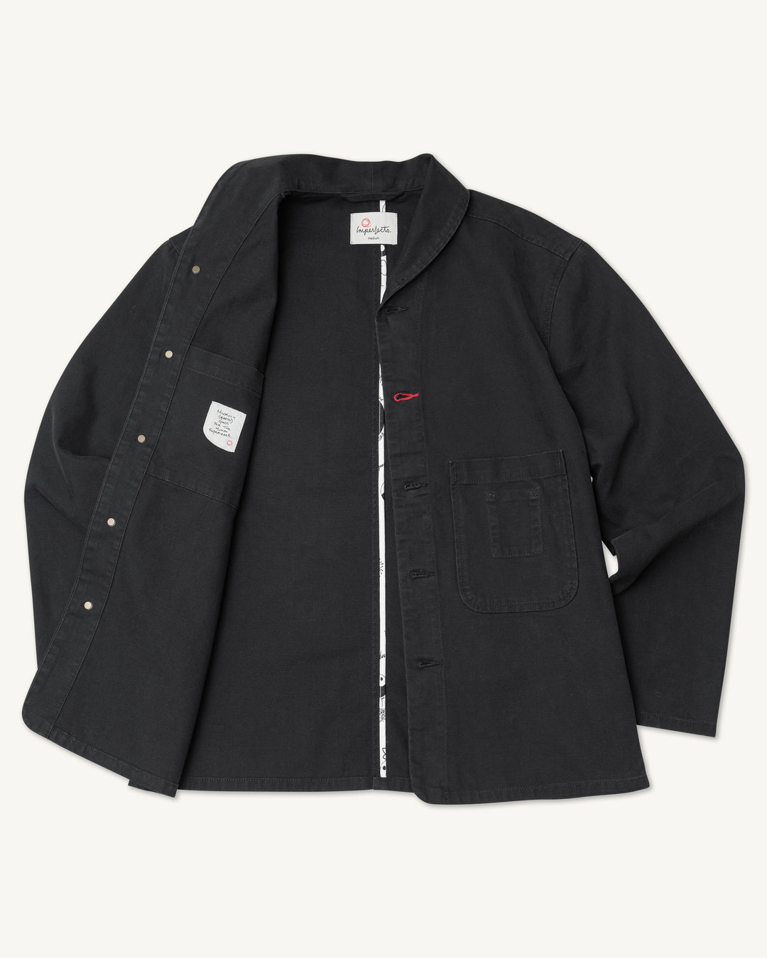 Imperfects - Shepherds Shirt Craft Canvas / Obsidian, a black handmade over-shirt with a collar, two front pockets, and an open front revealing a patterned inner lining.