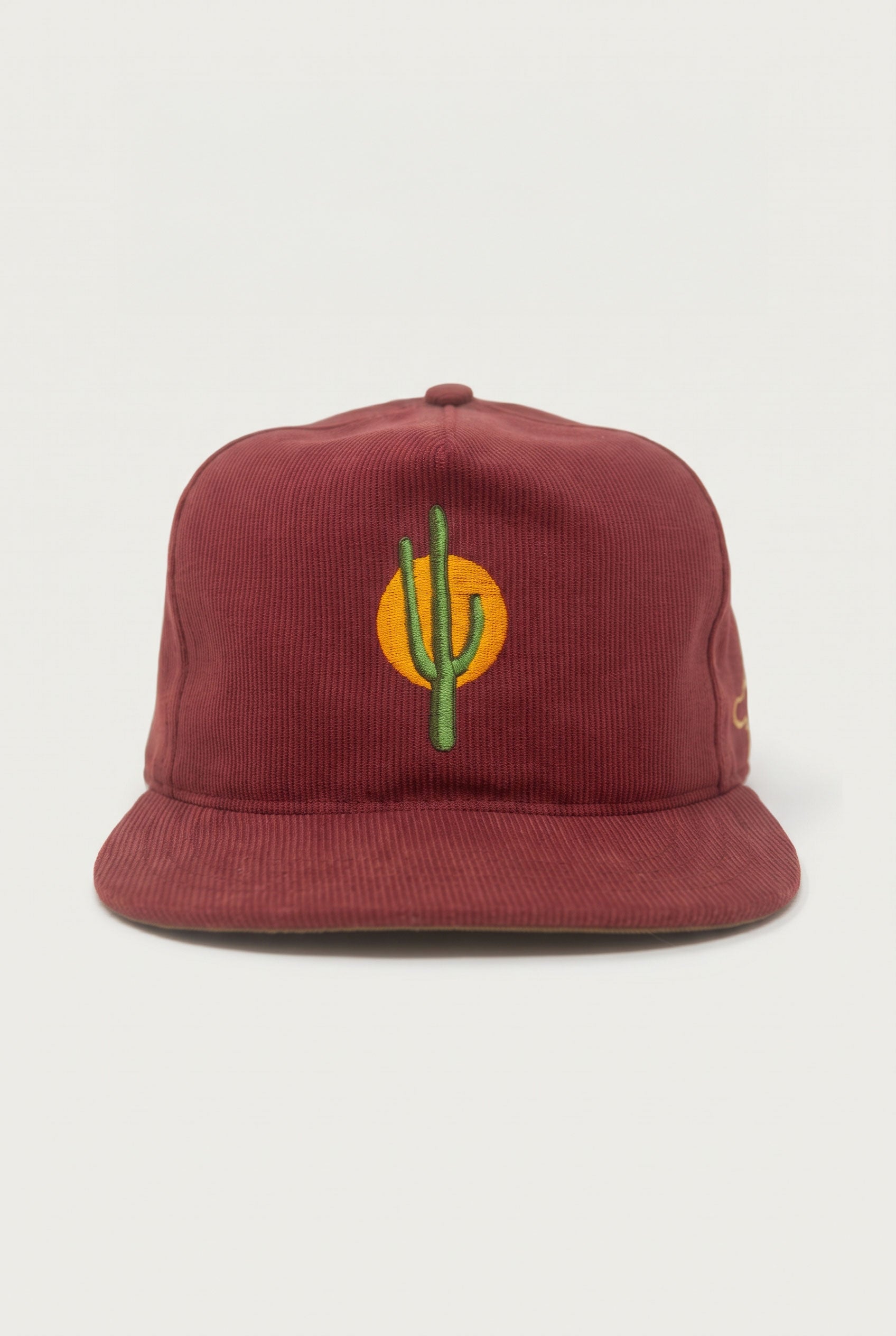 The Ampal Creative - Sunset Cactus / Brick maroon Bedford cloth baseball cap featuring an embroidered green cactus in front of a yellow sun.