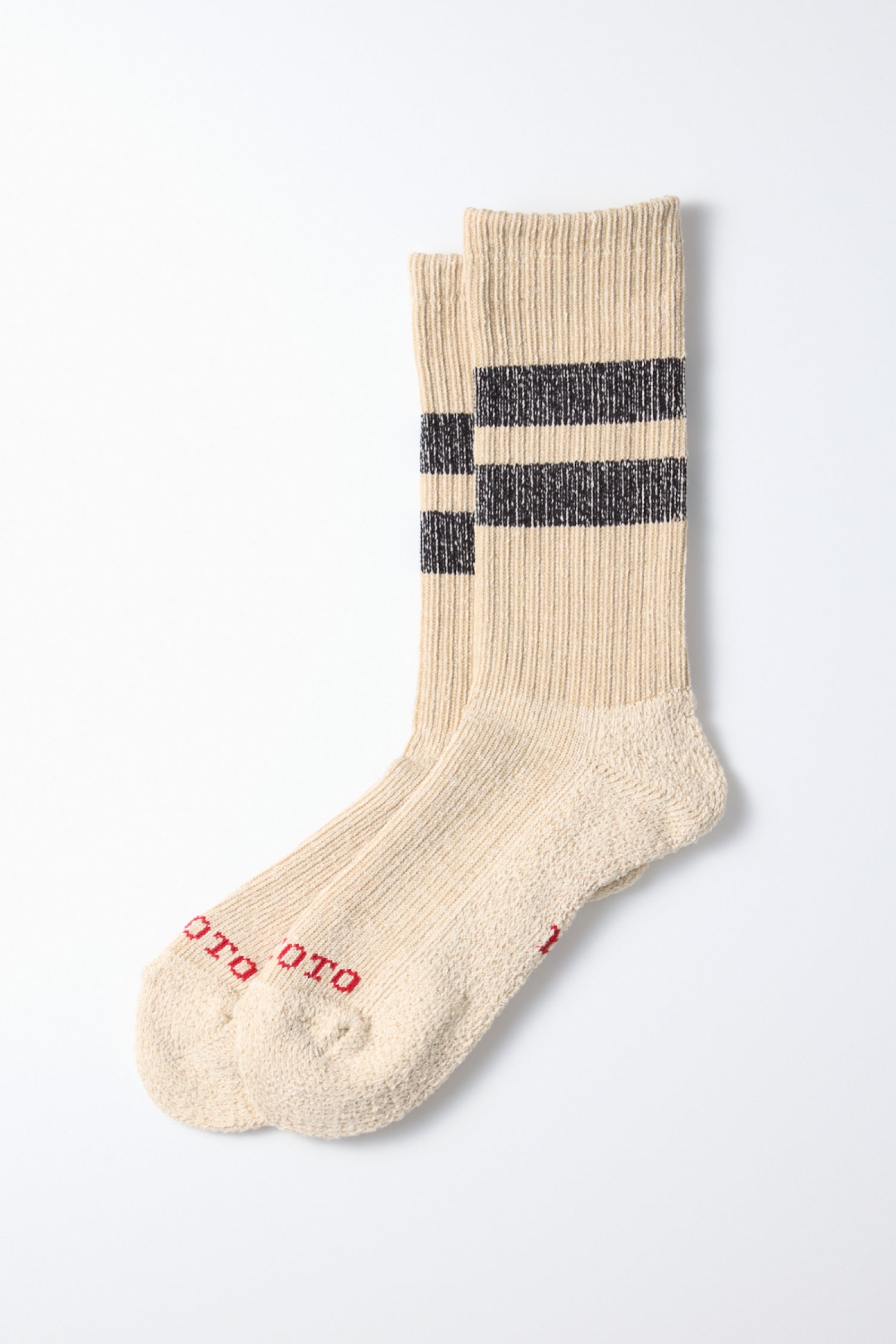 RoToTo Pile Stripe Marl Socks in Beige Black: a pair of ribbed organic cotton socks with two dark stripes near the top and red toe text, laid flat on a white background. Comfortable everyday socks made in Japan by RoToTo.