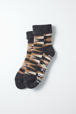 RoToTo Merino Lambs Wool Room Socks "Native" in Charcoal by RoToTo—cozy, chunky socks with a brown, beige, and black pattern, dark gray toes and cuffs, plus non-slip white designs on the soles. Expertly made in Japan for superior comfort.