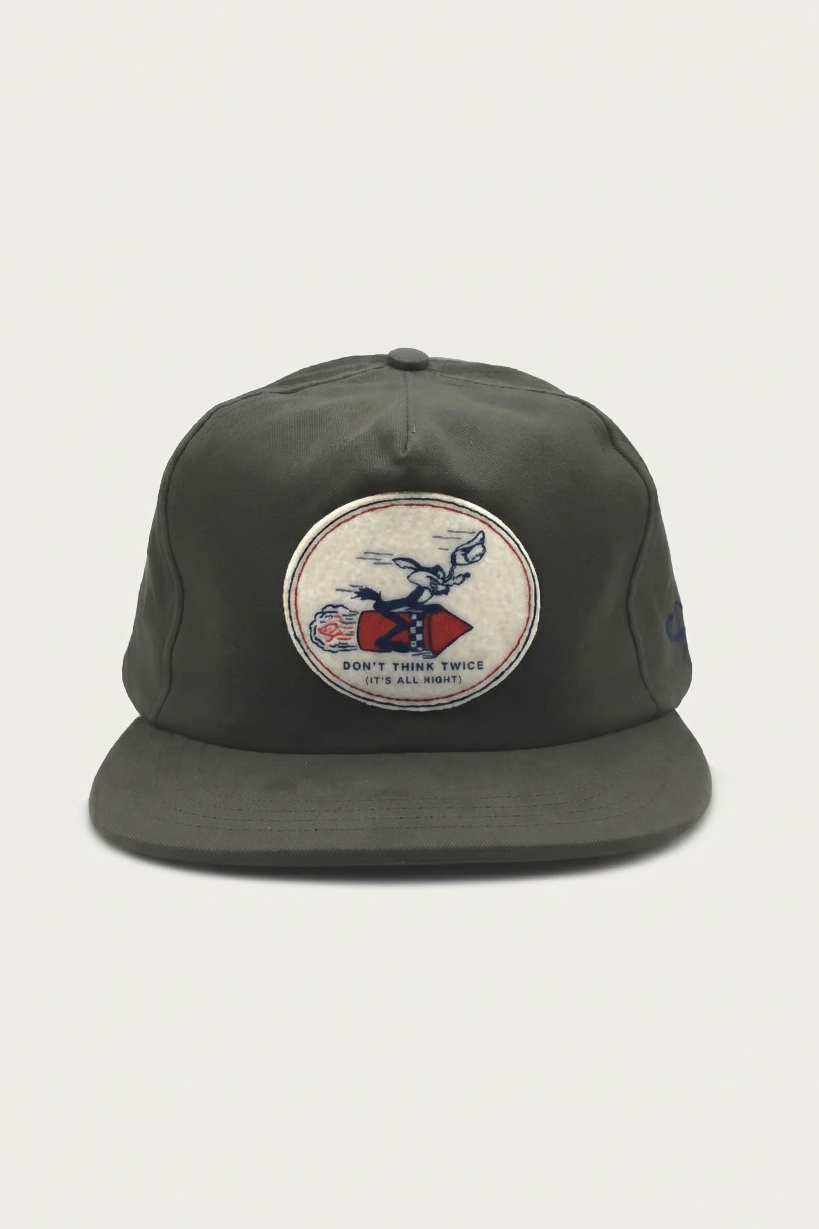 Olive green The Ampal Creative - Don’t Think Twice Strapback / Olive baseball cap with a circular cotton twill patch featuring a cartoon character riding a rocket and the text DONT THINK TWICE (ITS ALL RIGHT).