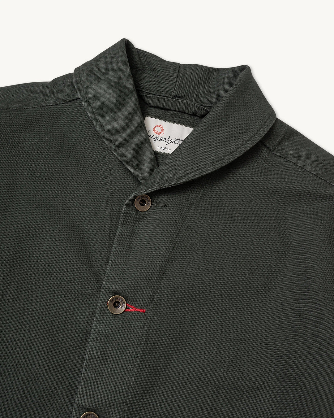 Imperfects - Shepherds Shirt Craft Canvas / Greenroom in dark olive organic cotton, featuring a kimono-style shawl collar, button-front closure, and red thread detail on the second button.