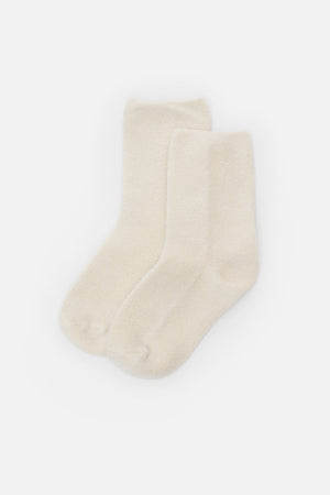 A pair of Le Bon Cloud Socks in Ecru, featuring a soft terry knit and ankle-length design, is laid flat on a white background.