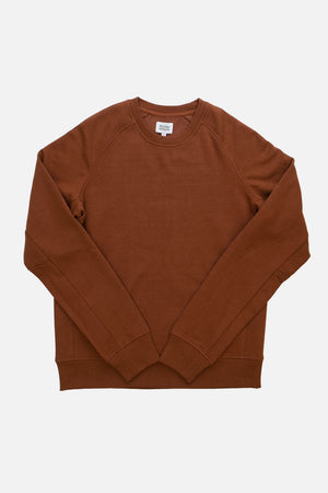 The Bridge & Burn Fremont Crew Sweatshirt in Burnt Umber, a sustainable long-sleeve crewneck, is laid flat on a white background.