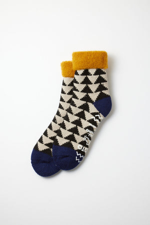 RoToTo Comfy Room Sankaku Socks by RoToTo in Gold, Black, and Navy feature a black and white houndstooth pattern, yellow cuffs, and navy toes and heels, shown laid flat on a white background.