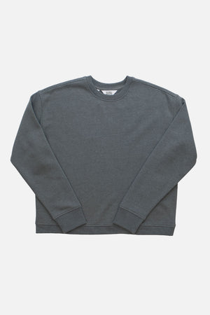 The Bridge & Burn Hawthorne Boxy Crew Sweatshirt in Storm Blue features a sustainable, long-sleeved, crew neck design and a boxy fit, shown laid flat on a white background.