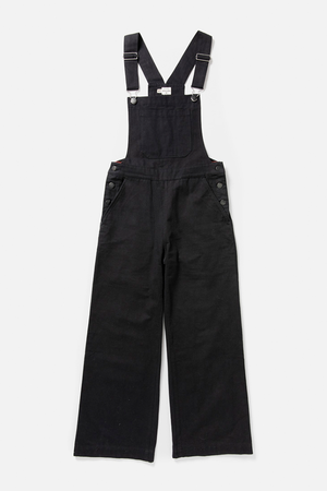 Bridge & Burn’s Roscoe Overall in Black Canvas features a wide leg, adjustable straps, front bib, side buttons, and front pockets. Shown laid flat on a white background.